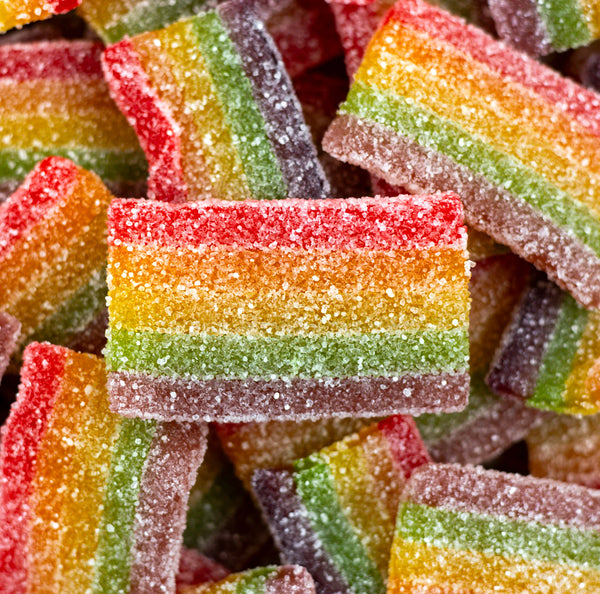 Sour Magic Carpets — Rainbow-striped gummy strips that spark your taste buds with a sour swirl of fruity flavors