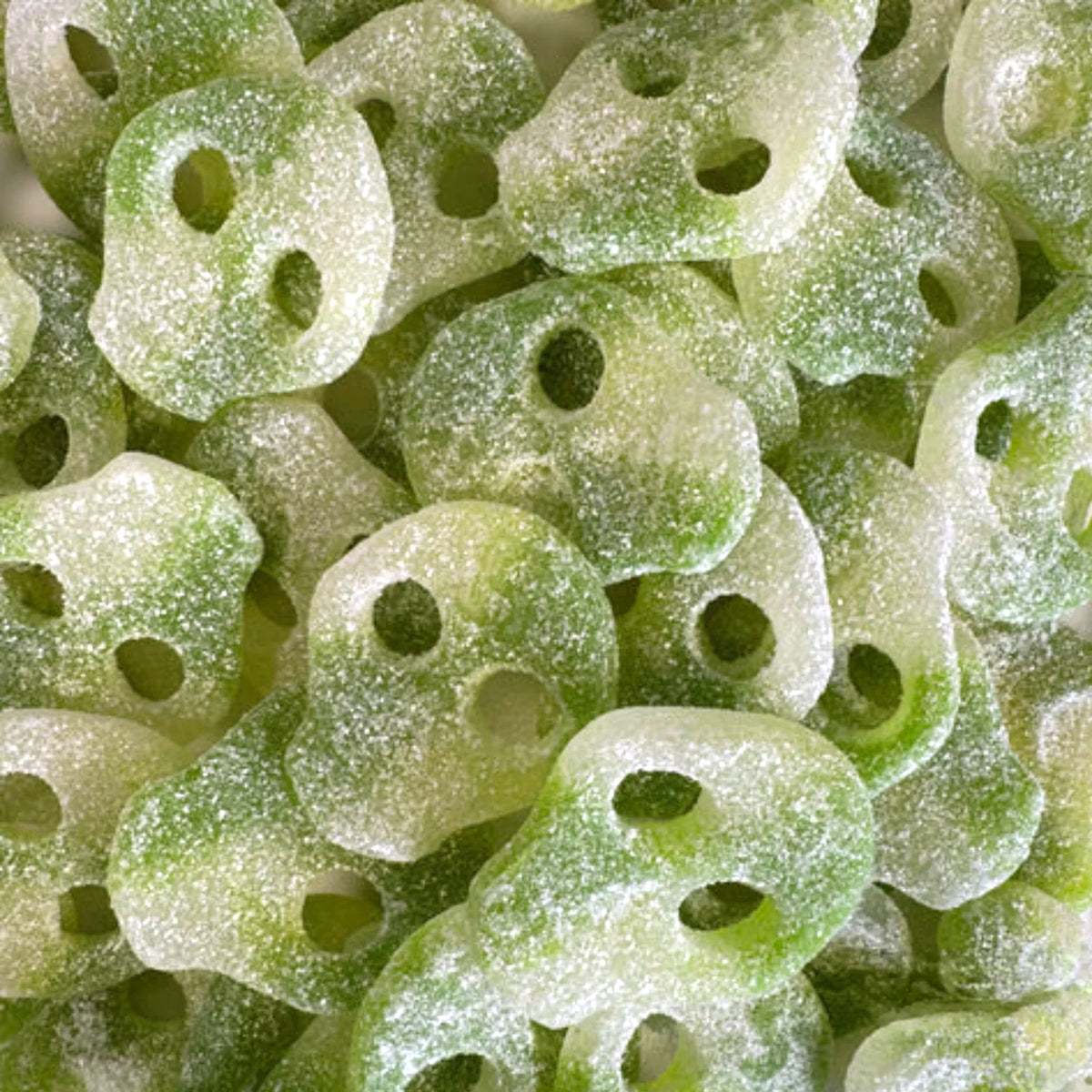 Sour Apple Skulls — Green apple with bite. Tender gummy skulls dusted in sour sugar
