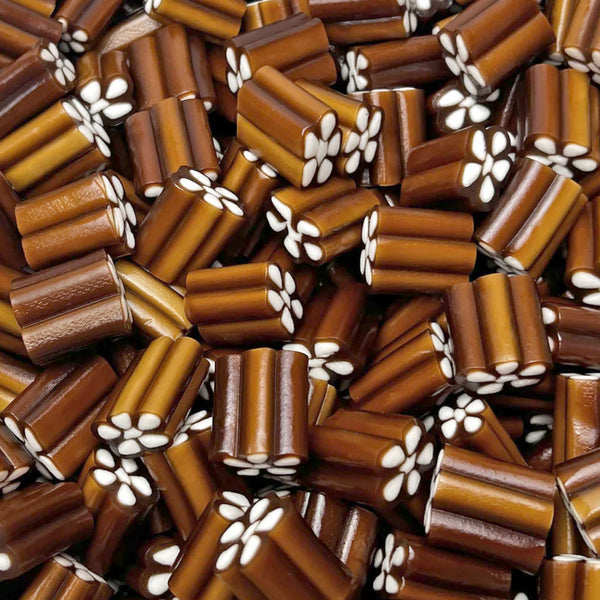 Cola Revolvers — Classic cola candy shaped like a revolver cylinder, finished with a rich vanilla fondant center